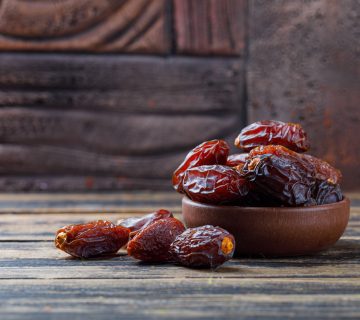 Sweet dates clay plate stone tile wooden background 360x320